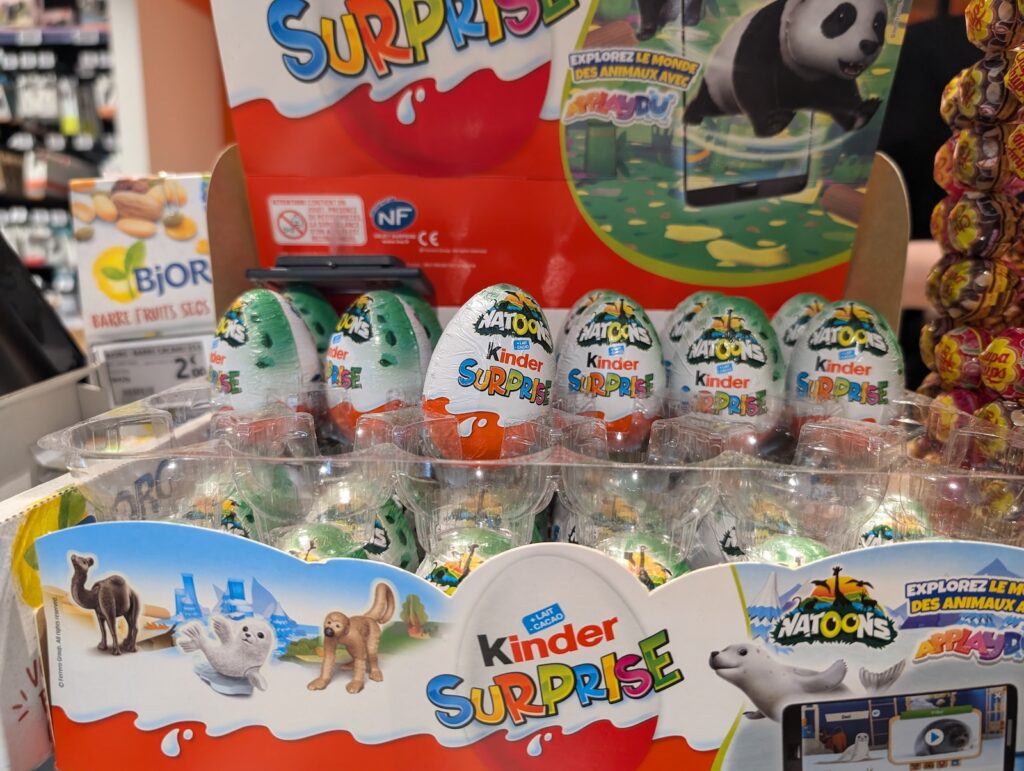 France, 28 July 2024: Display of Kinder Surprise eggs in a supermarket aisle