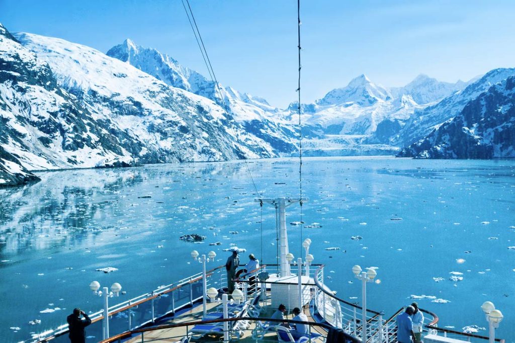 Glacier Bay National Park, Alaska Passengers aboard a cruise ship enjoy the majestic view of one of Alaska's many beautiful glaciers. Cruise ships typically spend a full day in Glacier Bay including a stop at a major tidewater glacier.