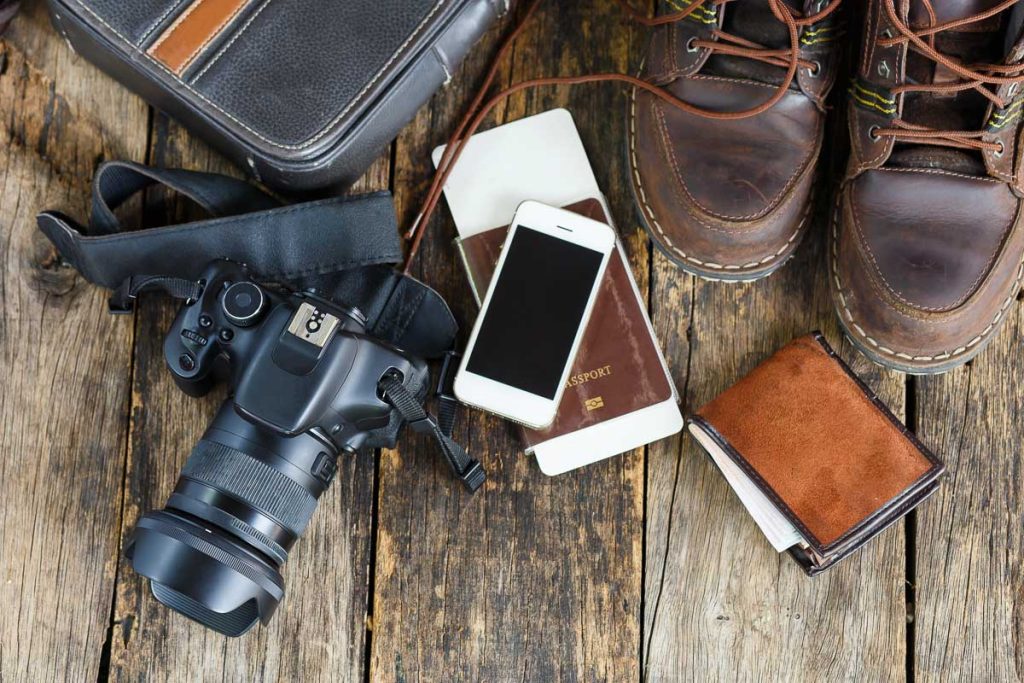 holiday concept, Preparation for travel,smartphone money and passport with camera on wooden table